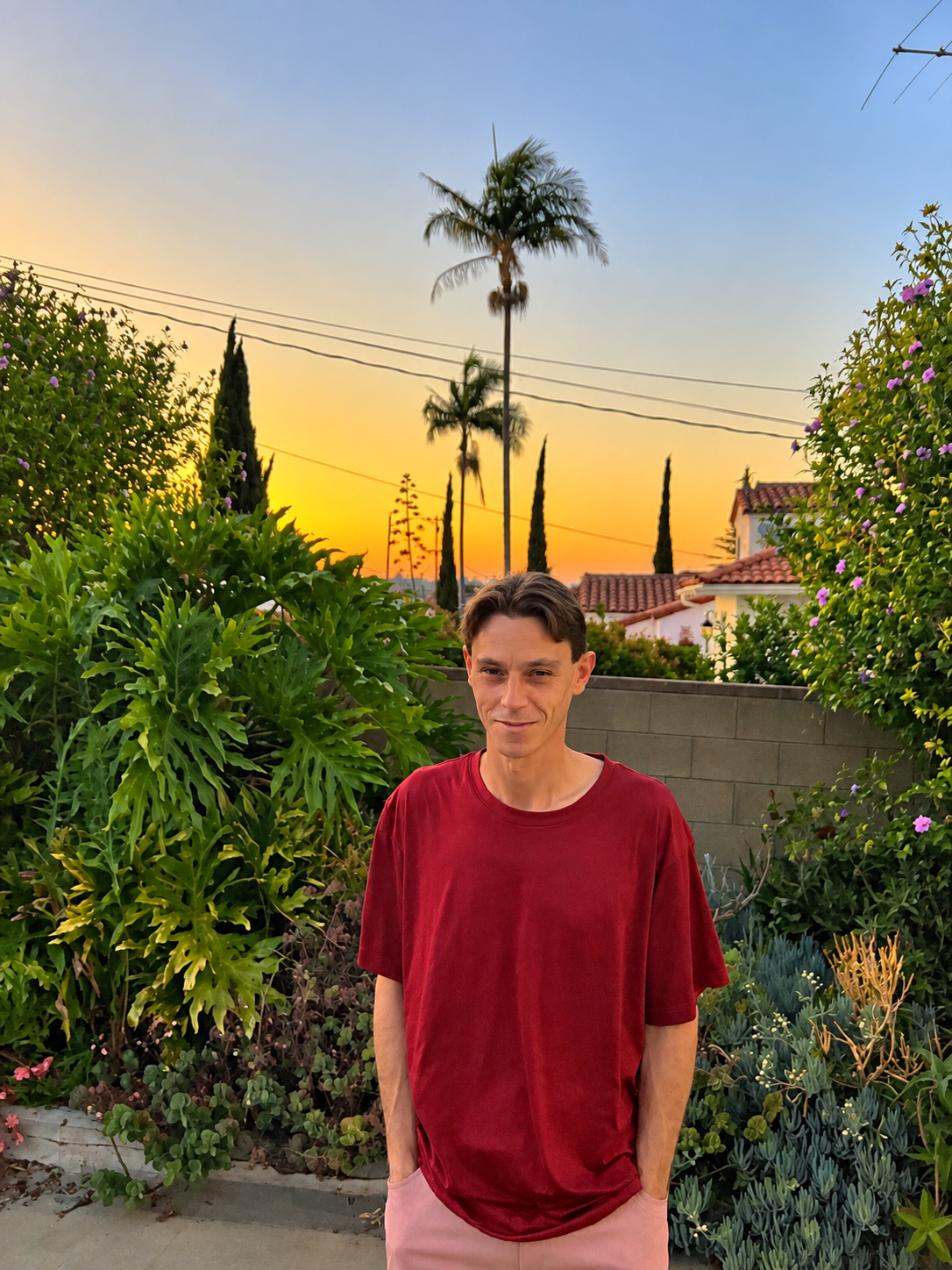 Matt Finney standing in a garden at sunset
